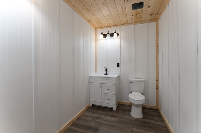 bathroom with wooden ceiling, wood-type flooring, vanity, and toilet