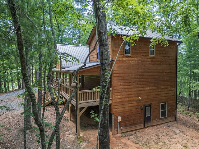 view of side of home featuring a wooden deck