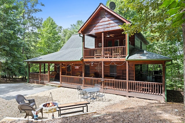 264 Summit St, Ellijay, GA 30540 - rear view of house with a fire pit, a patio area, a ceiling fan, roof with shingles, and a balcony