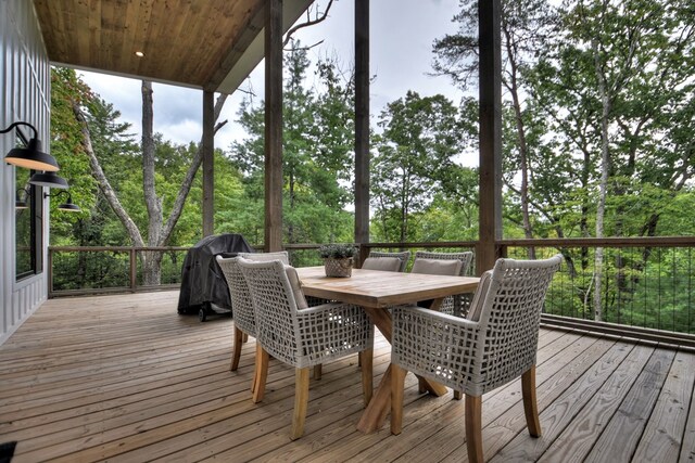 wooden deck featuring a grill