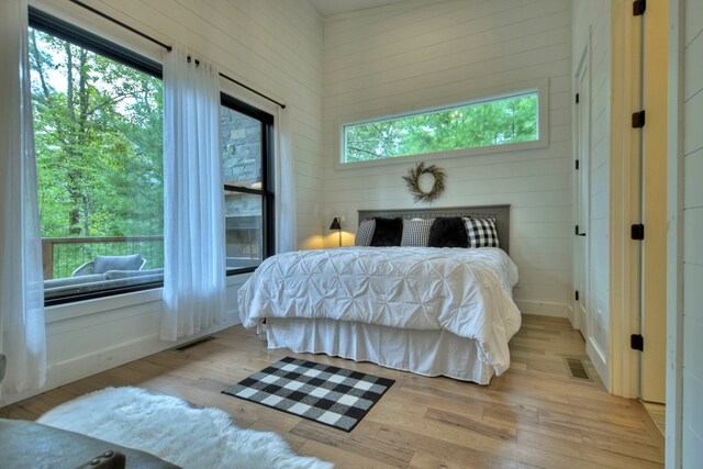 bedroom with light hardwood / wood-style flooring and multiple windows