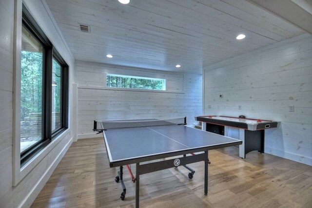 playroom featuring wood ceiling, plenty of natural light, light hardwood / wood-style flooring, and wooden walls