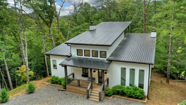 back of house featuring a porch