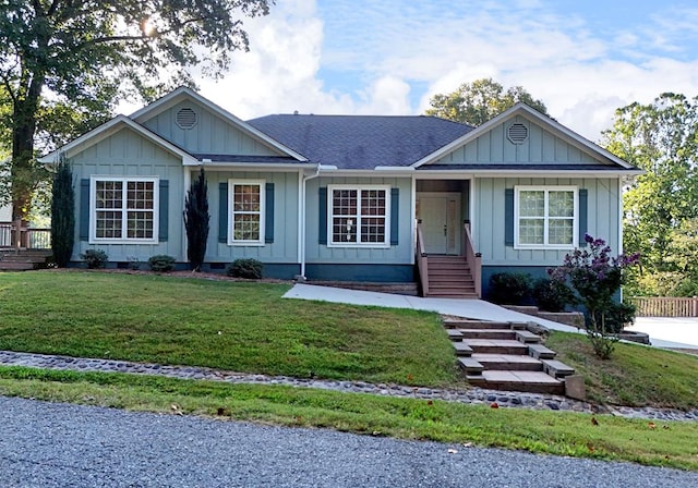 ranch-style home with crawl space, a shingled roof, board and batten siding, and a front yard