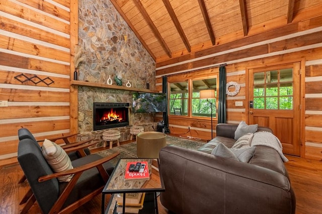 421 Weeks Creek Rd, Blue Ridge, GA 30513 - living area featuring wooden ceiling with exposed beams, healthy amount of natural light, wood finished floors, a stone fireplace, and wooden walls