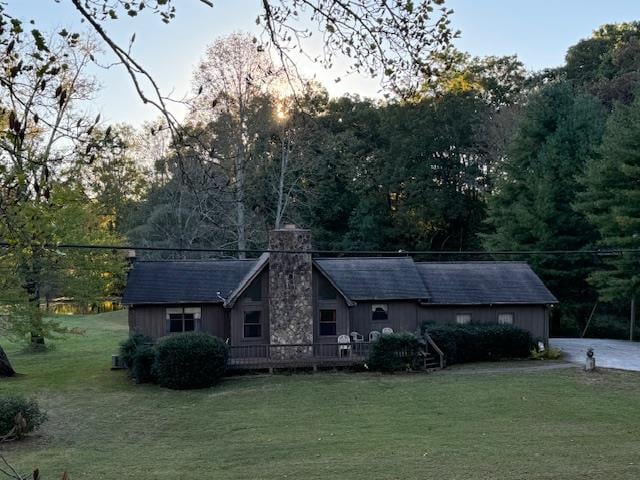 view of front of property with a front yard and a chimney