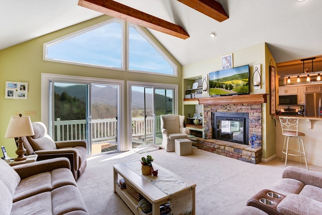 living room featuring beam ceiling, a stone fireplace, high vaulted ceiling, and light colored carpet