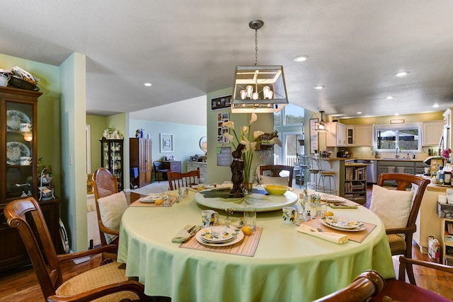 dining area with a textured ceiling, sink, and hardwood / wood-style flooring