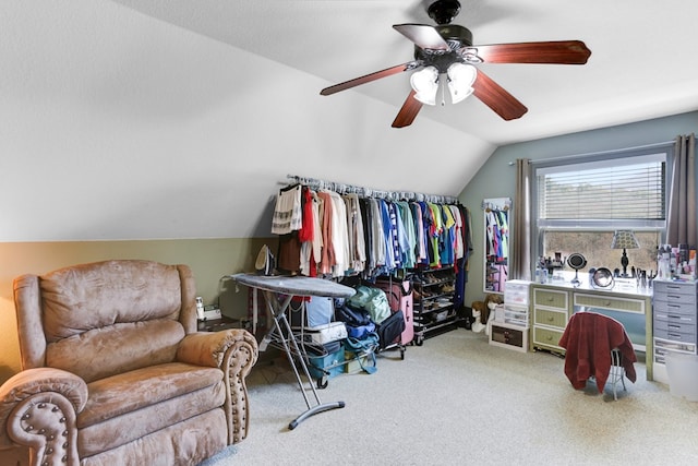 walk in closet featuring light carpet, lofted ceiling, and ceiling fan