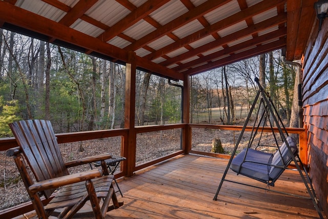 unfurnished sunroom featuring lofted ceiling