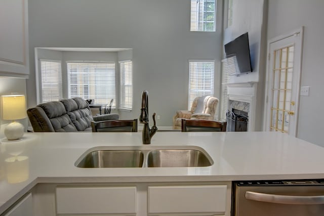 4149 Spring Cove Dr, Duluth, GA 30097 - kitchen with a sink, dishwasher, open floor plan, a high end fireplace, and white cabinets