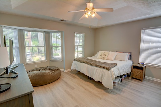4149 Spring Cove Dr, Duluth, GA 30097 - bedroom featuring light wood-type flooring, baseboards, ceiling fan, and a tray ceiling