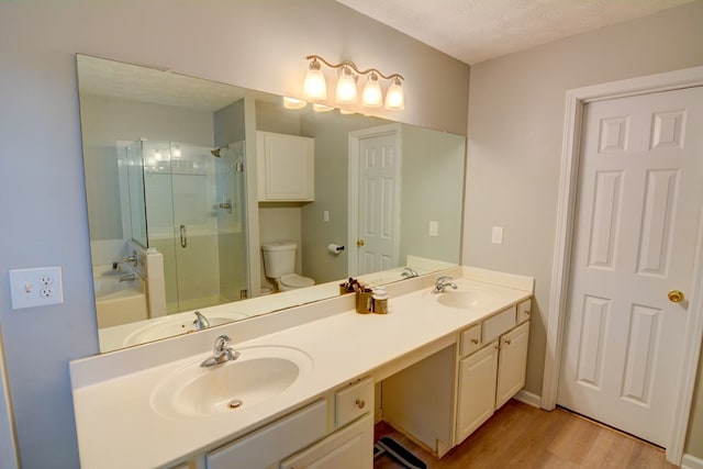 4149 Spring Cove Dr, Duluth, GA 30097 - full bath with a stall shower, double vanity, wood finished floors, a bath, and toilet