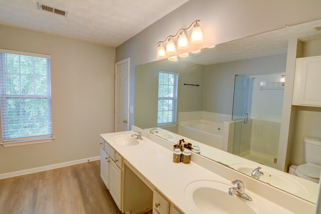 4149 Spring Cove Dr, Duluth, GA 30097 - full bath with wood finished floors, toilet, a bath, double vanity, and a stall shower