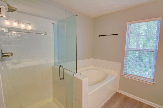 4149 Spring Cove Dr, Duluth, GA 30097 - bathroom featuring a shower stall, wood finished floors, a bath, and baseboards