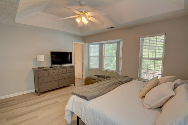 4149 Spring Cove Dr, Duluth, GA 30097 - bedroom featuring a tray ceiling, light wood-style floors, baseboards, and ceiling fan