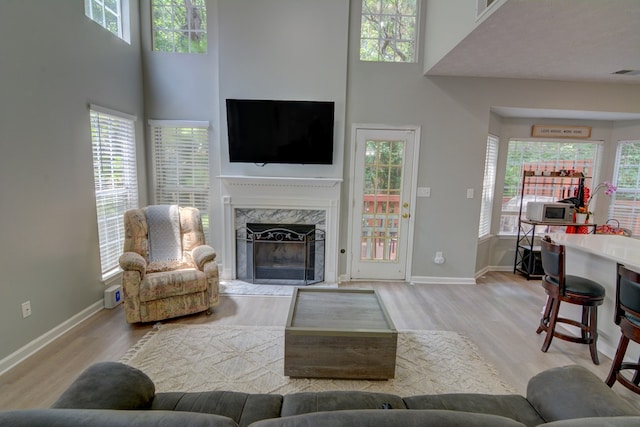 4149 Spring Cove Dr, Duluth, GA 30097 - living room with wood finished floors, a fireplace, baseboards, and a towering ceiling