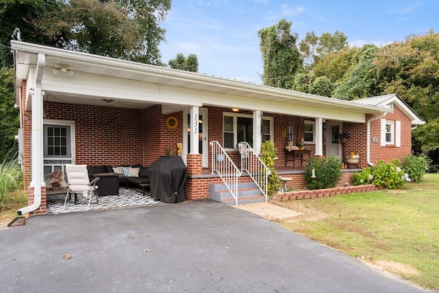 ranch-style house with an outdoor living space, a front lawn, and covered porch