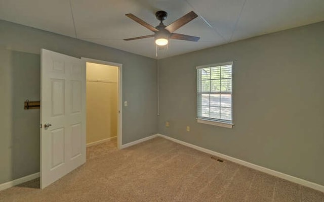 unfurnished bedroom featuring carpet floors and baseboards