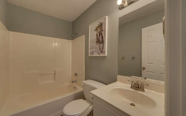 bathroom with vanity, bathing tub / shower combination, and toilet