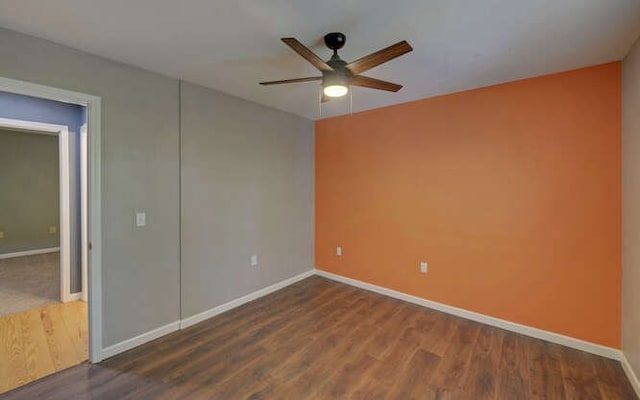 unfurnished room with baseboards, ceiling fan, and wood finished floors