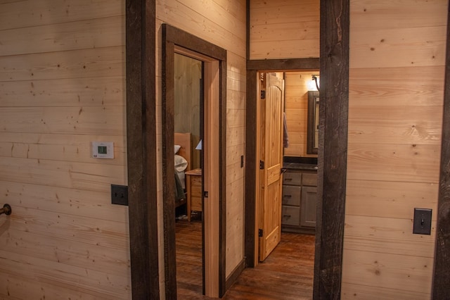 corridor featuring wooden walls and dark hardwood / wood-style floors