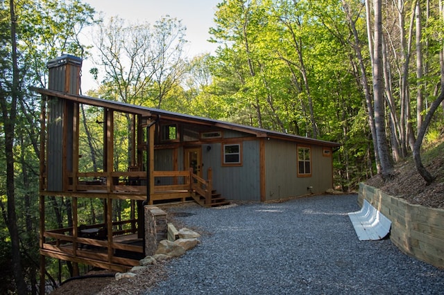 rear view of property featuring a wooden deck