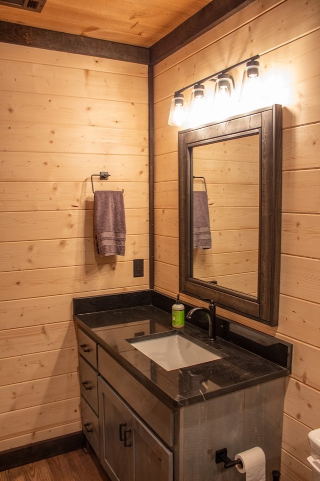 bathroom featuring hardwood / wood-style floors, wood walls, and wooden ceiling