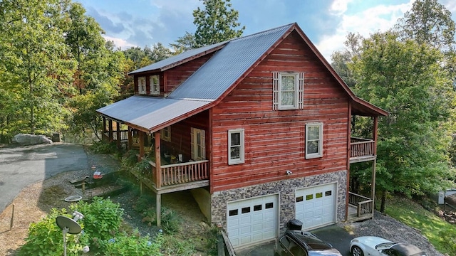 view of side of home with a balcony and a garage