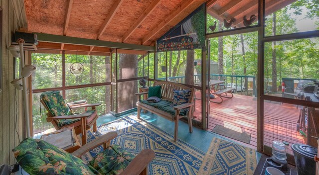 living area featuring lofted ceiling with beams, wood walls, and carpet