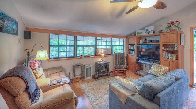 living room with light wood-type flooring, vaulted ceiling, and ceiling fan