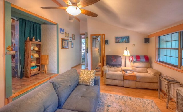 bedroom featuring vaulted ceiling, hardwood / wood-style floors, and washer / clothes dryer