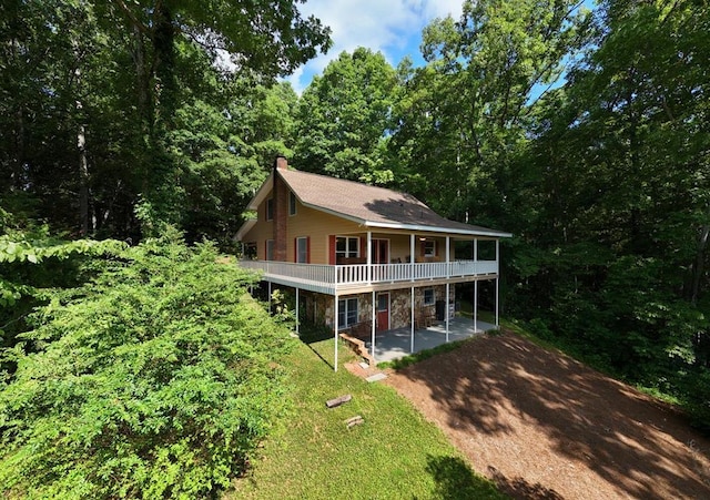 view of front of property with a deck and a patio