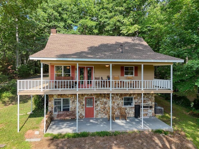 exterior space featuring a yard, central AC unit, a deck, and a patio area