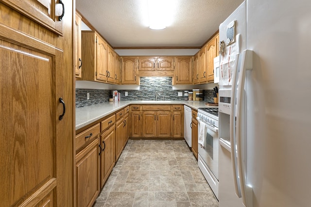 kitchen featuring light tile patterned flooring, white appliances, sink, a textured ceiling, and backsplash