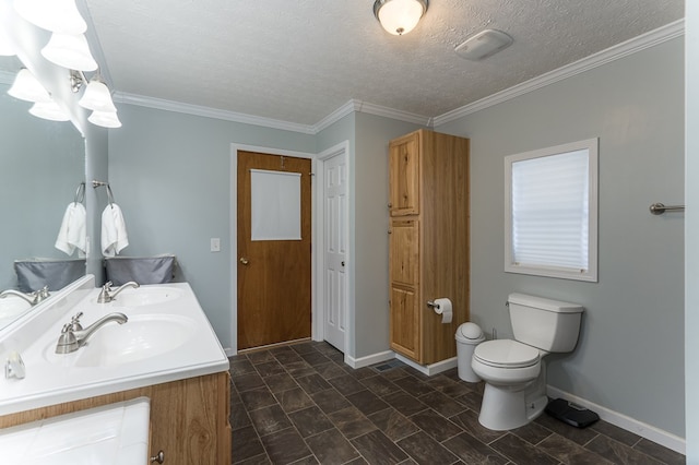 bathroom featuring double vanity, crown molding, toilet, and a textured ceiling