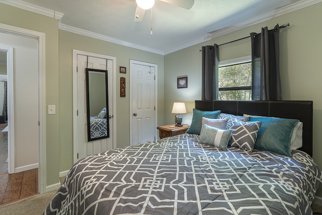 carpeted bedroom with crown molding, a textured ceiling, and ceiling fan