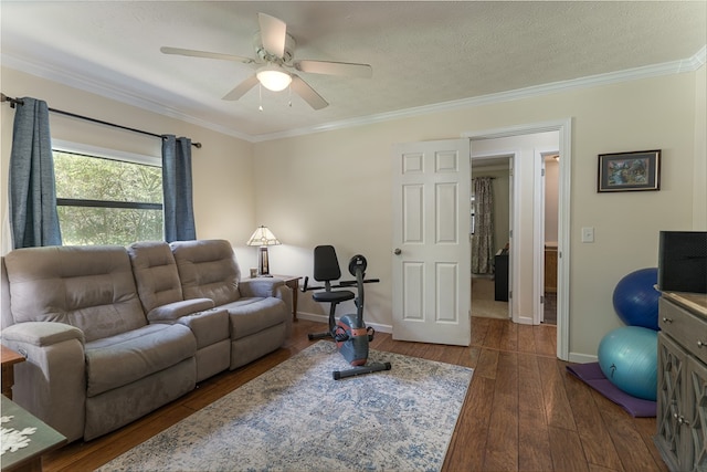 living room with crown molding, a textured ceiling, dark hardwood / wood-style flooring, and ceiling fan