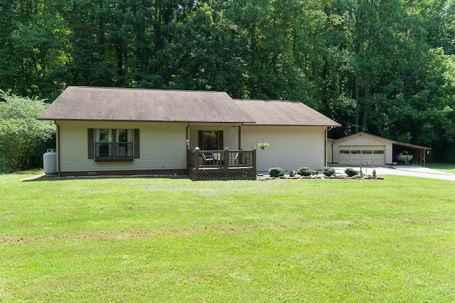 ranch-style home with a garage, an outbuilding, and a front yard