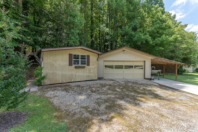 exterior space with a garage and an outbuilding