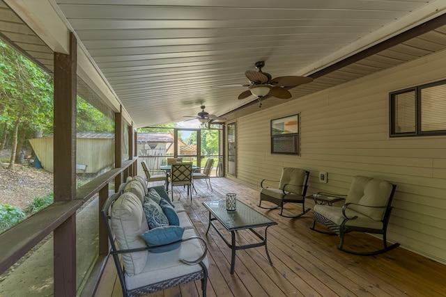 deck featuring outdoor lounge area, ceiling fan, and a storage unit