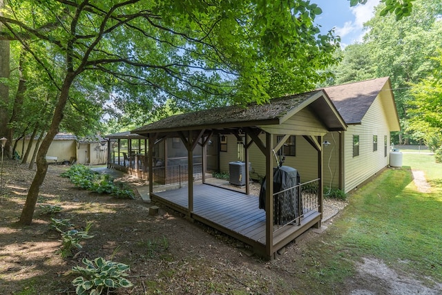 rear view of house with a deck and central AC