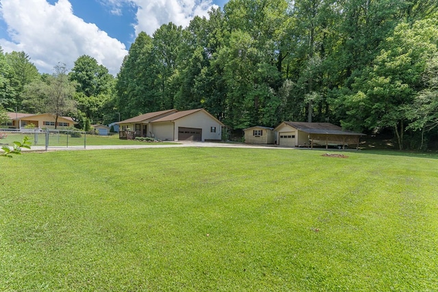 view of yard featuring a garage and an outdoor structure