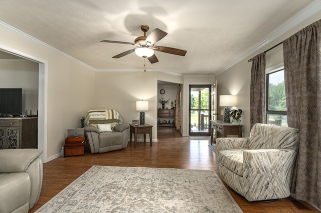 living room featuring crown molding, a textured ceiling, dark hardwood / wood-style flooring, and ceiling fan