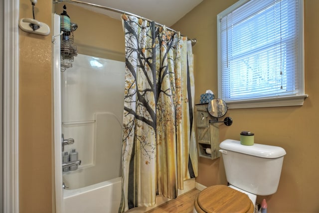 full bath featuring toilet, baseboards, shower / bath combination with curtain, and wood finished floors