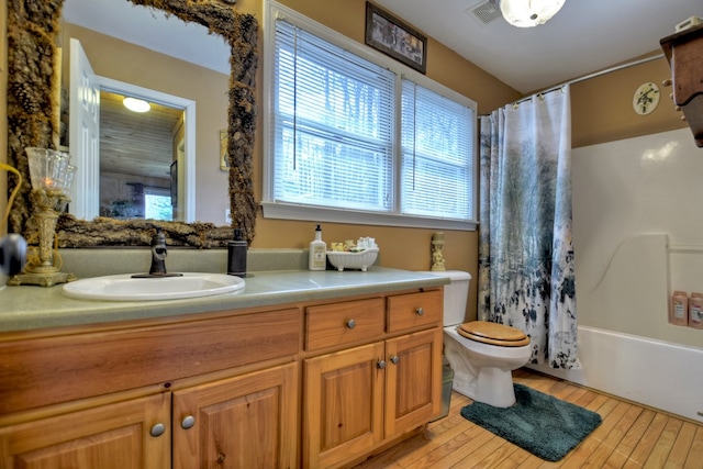 bathroom featuring visible vents, vanity, wood finished floors, and toilet