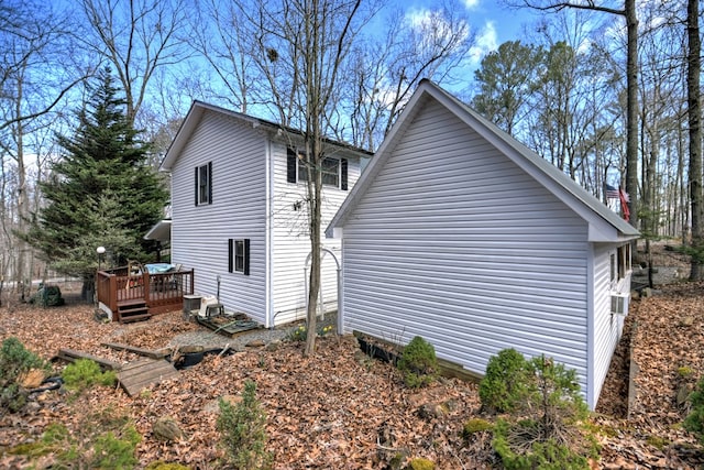 view of side of property with central AC and a wooden deck