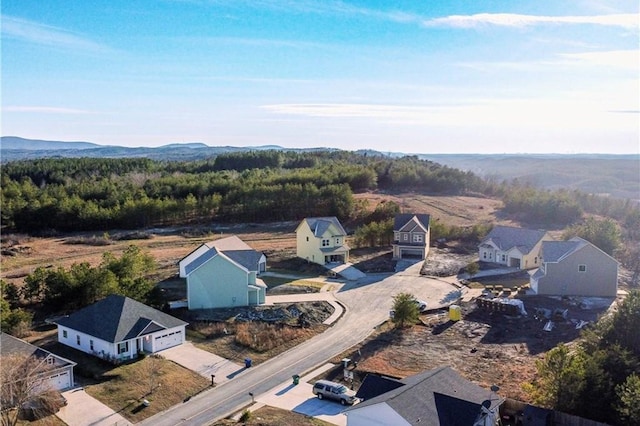 aerial perspective of suburban area featuring a heavily wooded area
