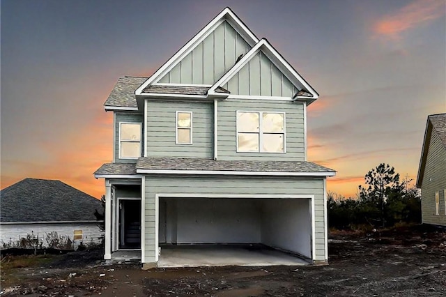 view of front of property featuring board and batten siding, a shingled roof, and a garage