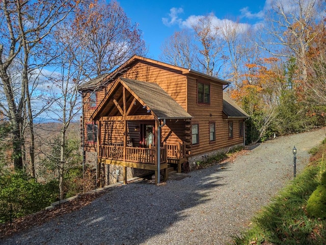 log-style house featuring a wooden deck